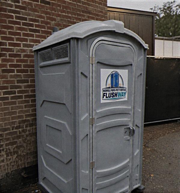 Portable toilet unit set up on a job site ready for use